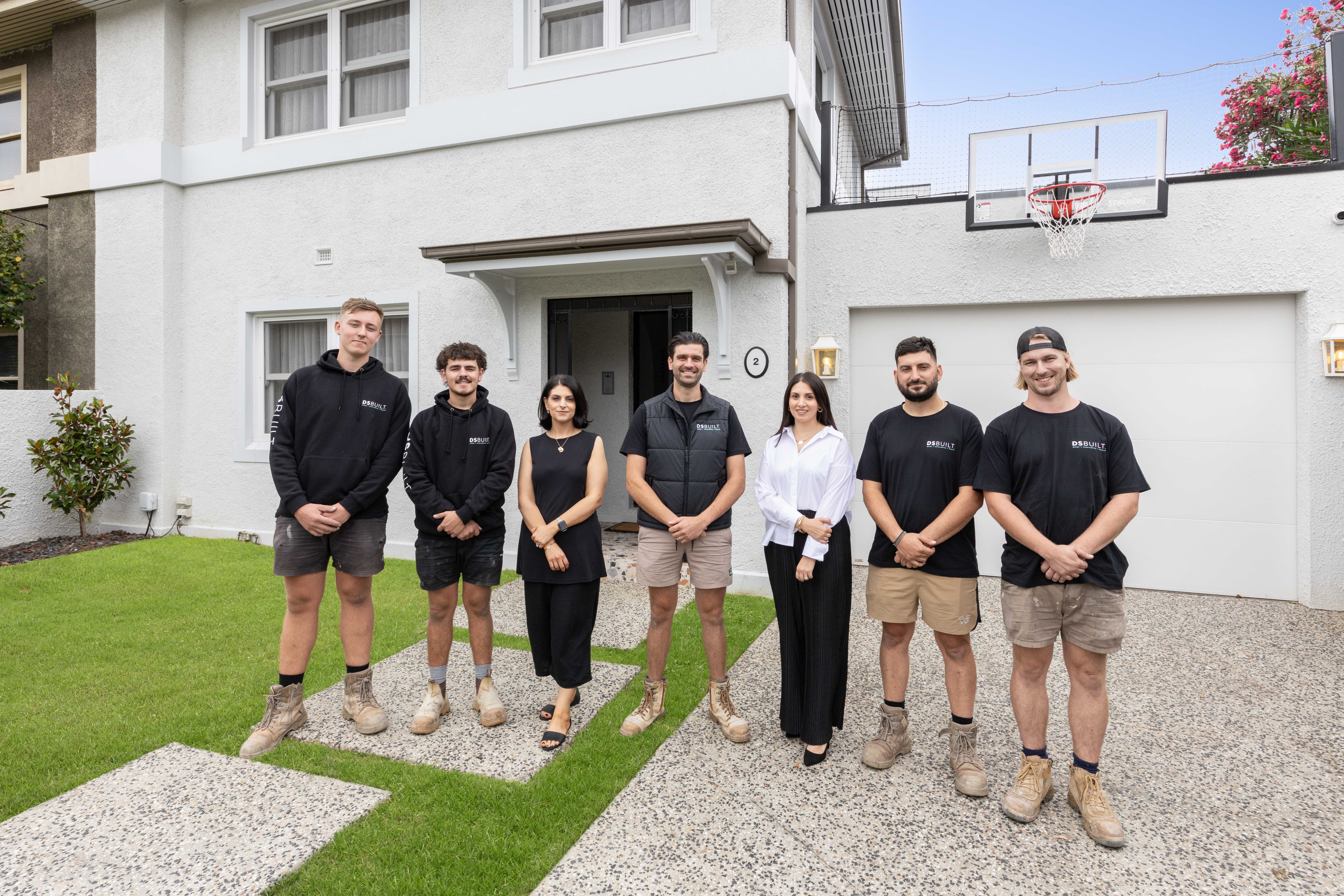 The DSBuilt team standing together outside a completed home