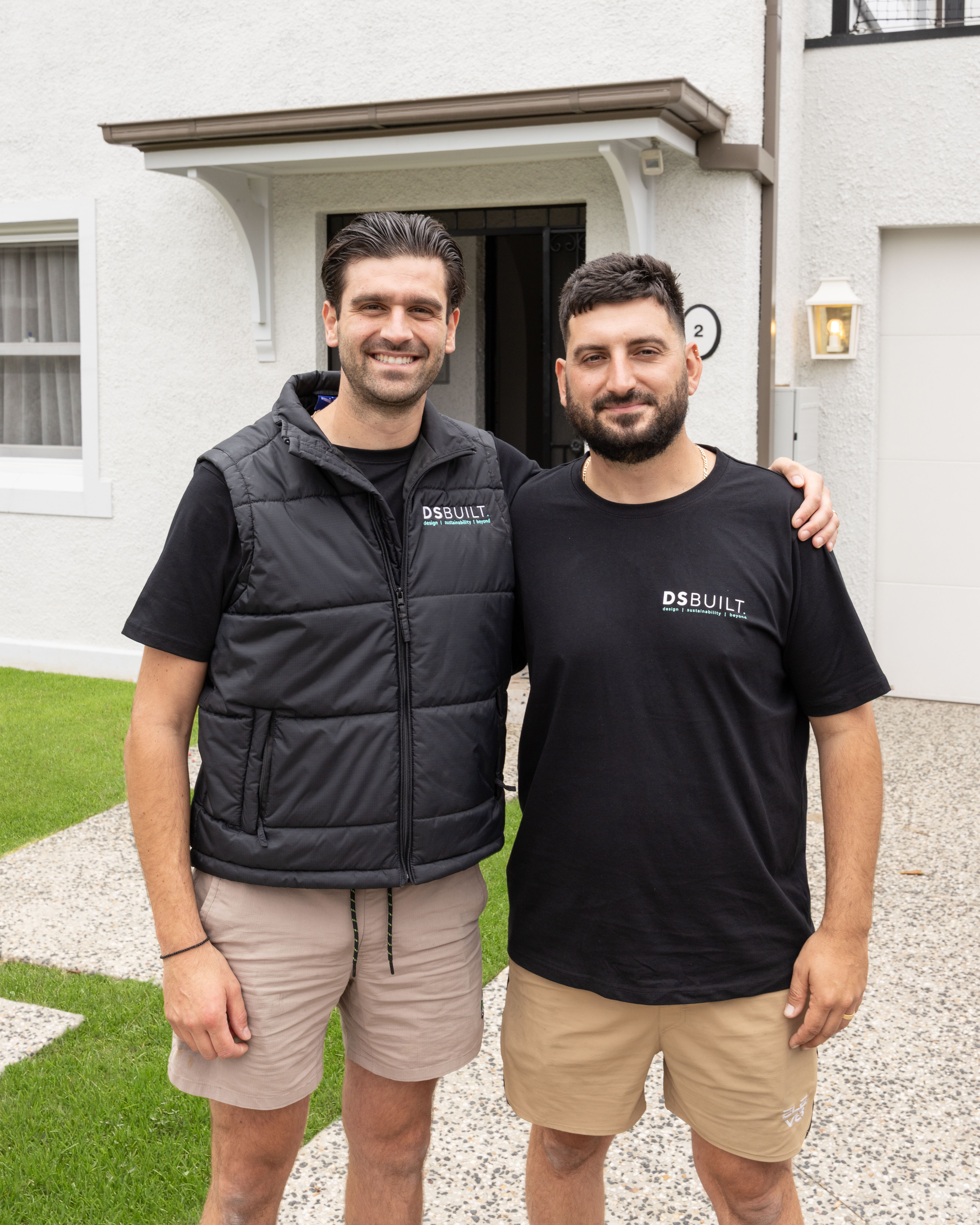 Two members of the DSBuilt team standing together outside a completed home